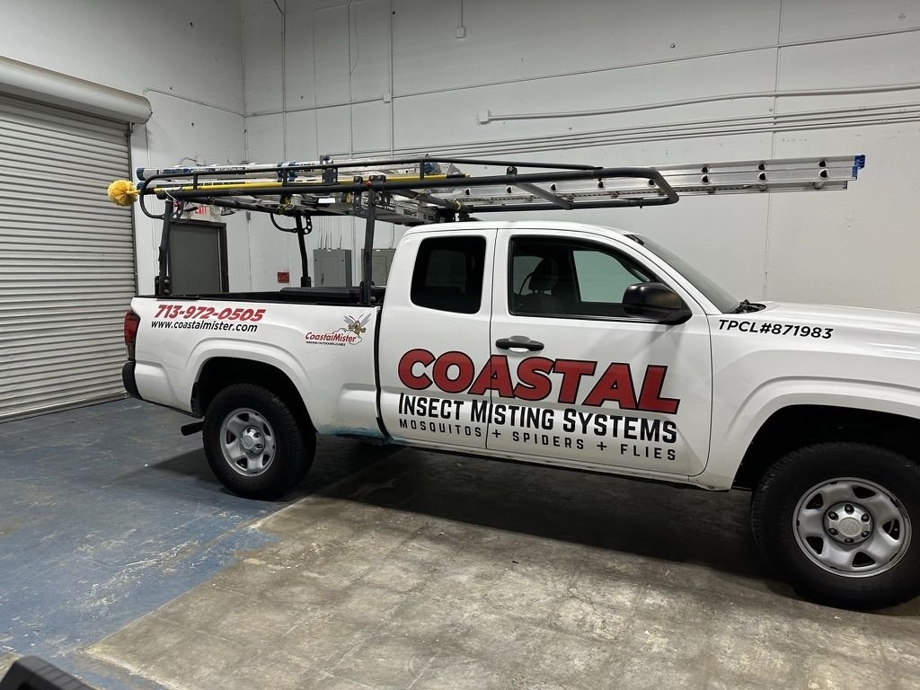 White pickup truck with company lettering and phone number in Houston